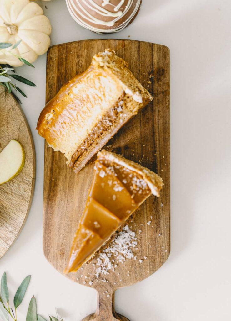 halloween snack board image   slices of caramel cheesecake on a wooden cutting board