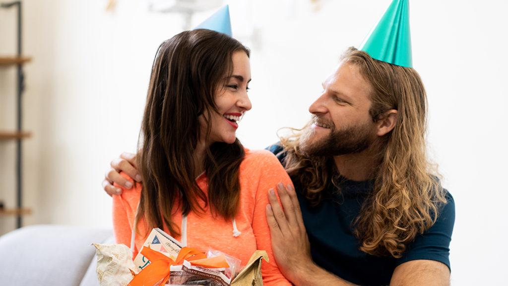 A photo of november birthdays with a couple exchanging gifts lovingly