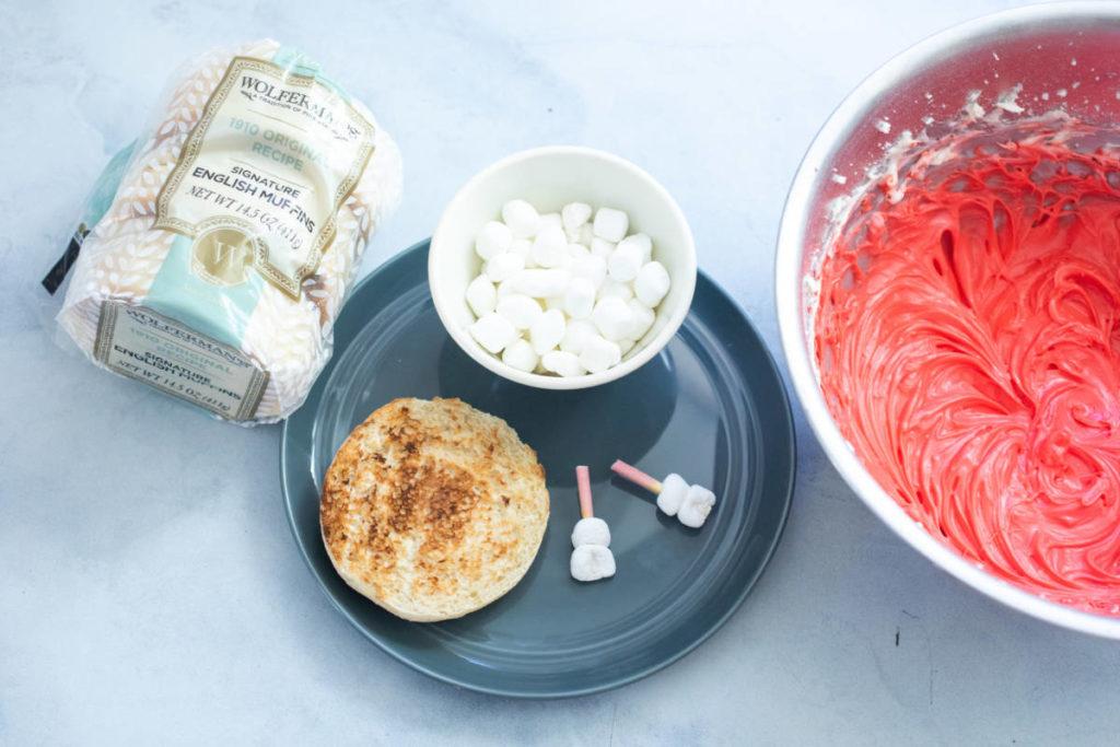 A photo of vampire fangs english muffins with ingredients ready to assemble.