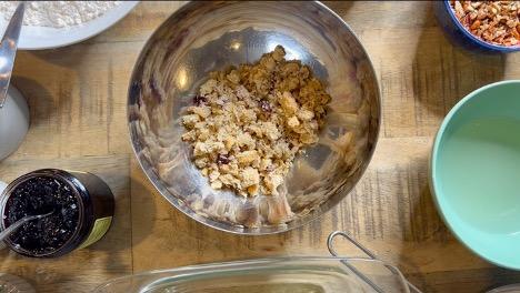 A photo of cobbler with a bowl of crumbled scones.