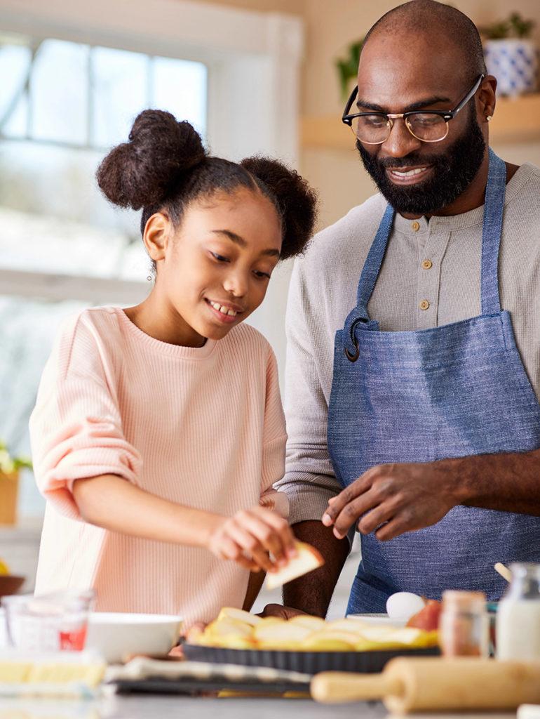 A photo of gifts for hard to buy for with a father and daughter cooking