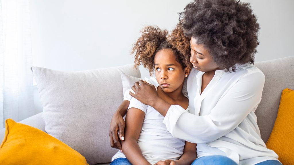 Photo of loss of dad on father's day with a woman comforting a young girl