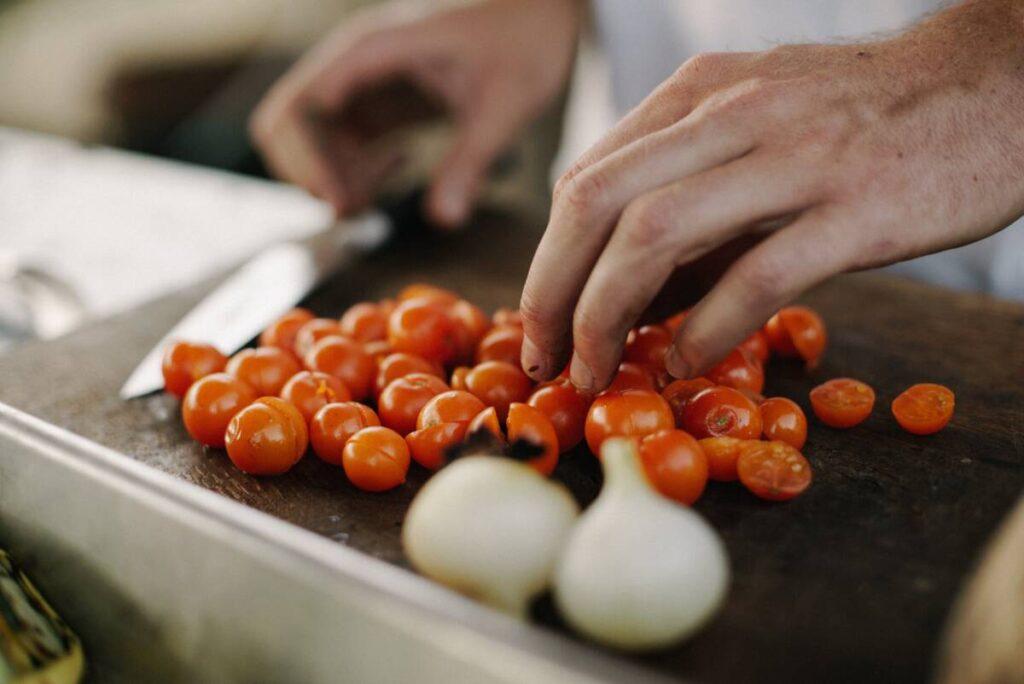 Cooking therapy with a person chopping tomatoes.