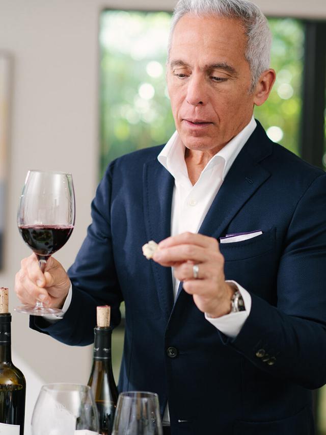 Geoffrey Zakarian wine and cheese in hand.