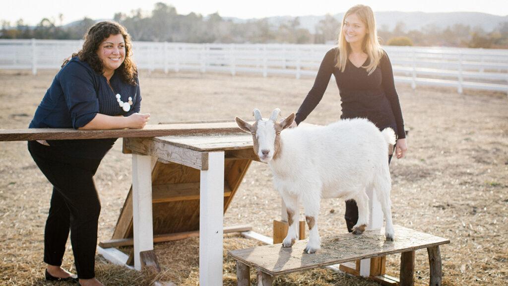 Vegan charcuterie board Renegade food founders standing in a field with a goat.