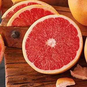 Slice of grapefruit on a wooden board.