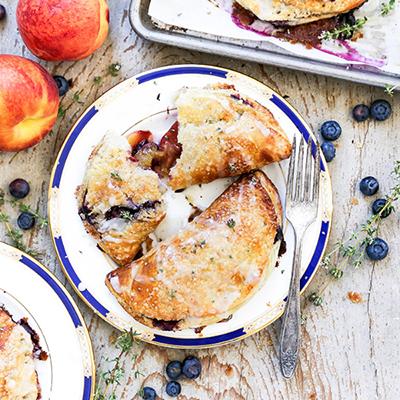 Types of pies with two blueberry hand pies.