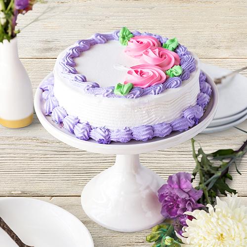 Types of cakes with an ice cream cake on a stand.