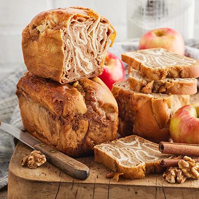 Types of pastries with two povitica on a wooden board.