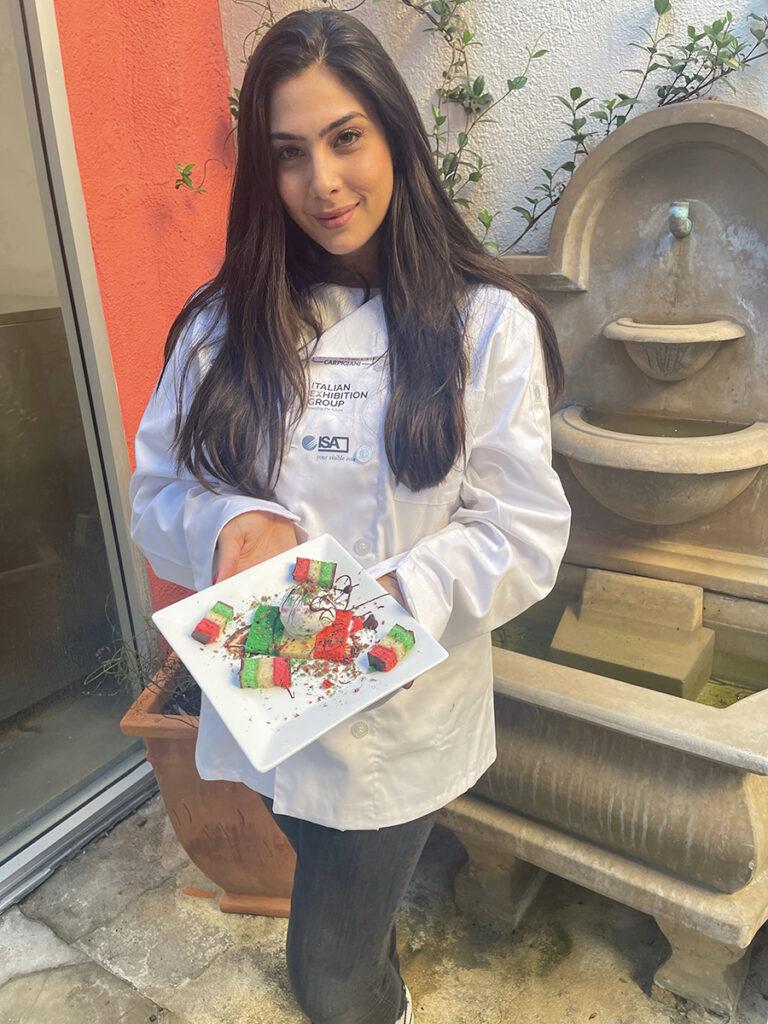 Janine Bruno holding a plate of food.