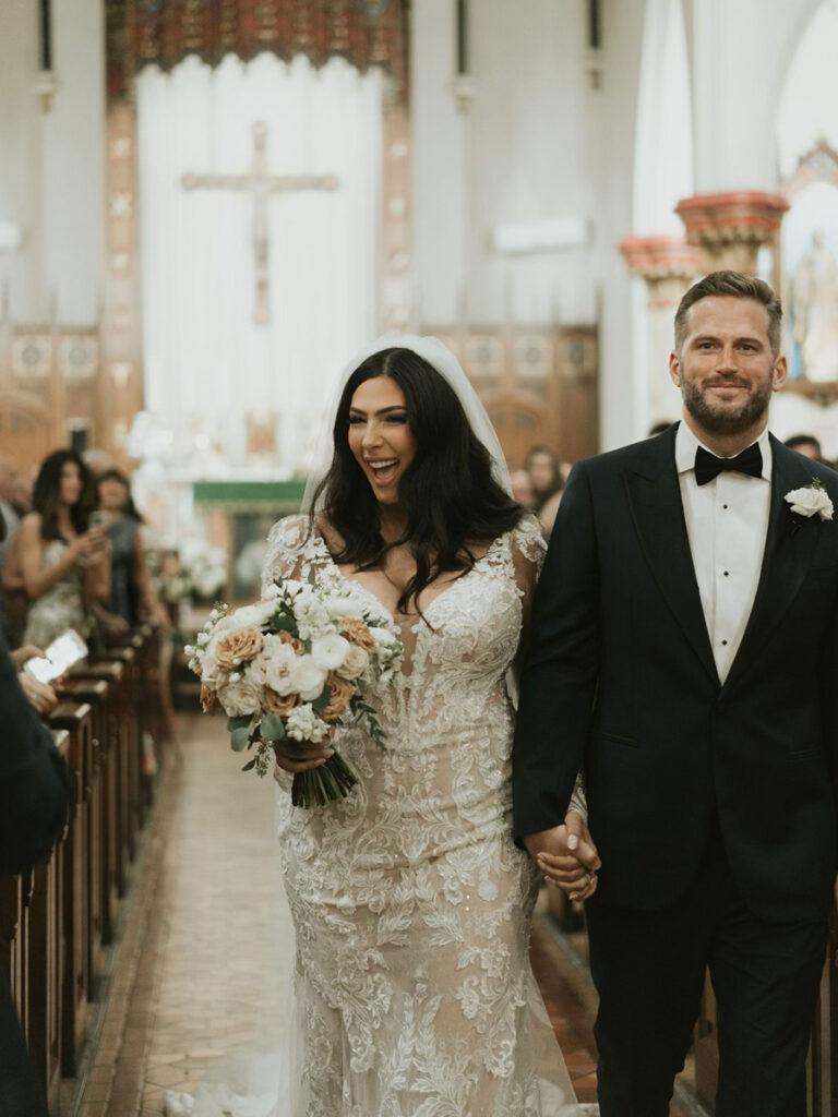 Janine Bruno and her husband walking down the aisle.