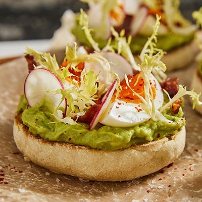 Breakfast for dinner with avocado toast on a plate.