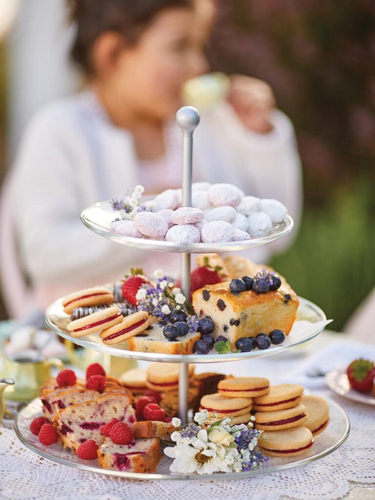 Tea party treats on a  tiered tray.