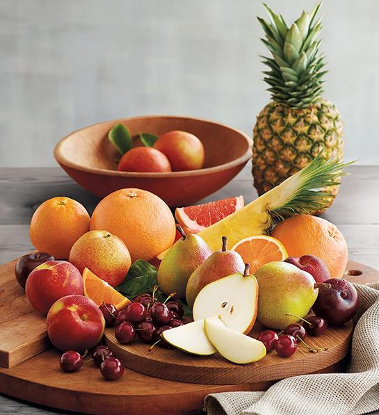 Thoughtful food gifts with a display of different types of fruit on a platter.