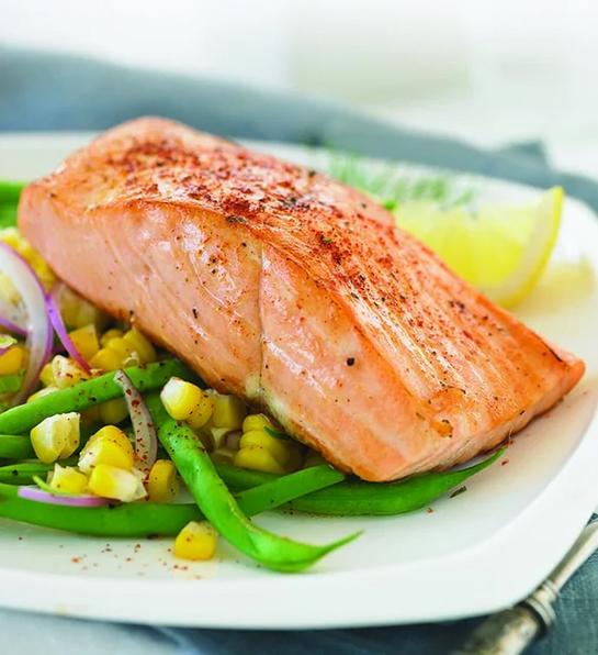 Thoughtful food gifts with a plate of cooked salmon and vegetables.